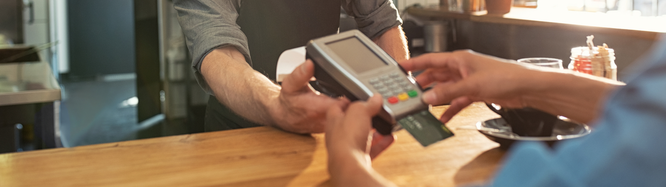 Customer paying a business by credit or debit card using a card machine
